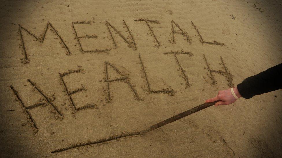 Imaging showing the words mental health written in sand