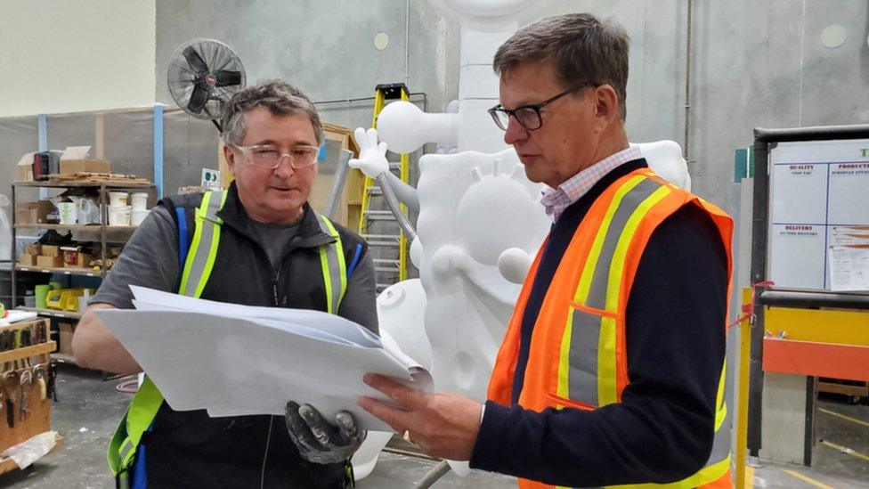 Geoff Chutter looking over plans with a Whitewater employee