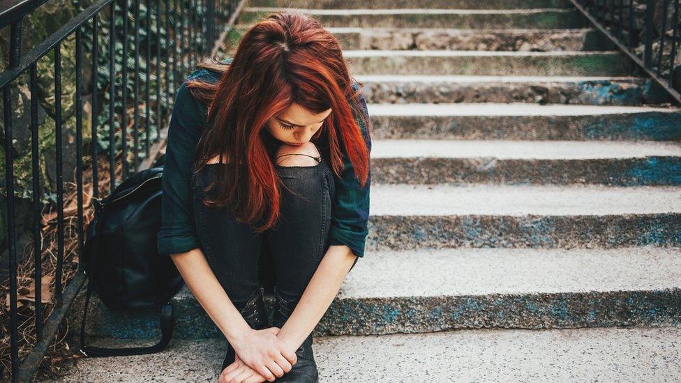 Young woman sat on steps