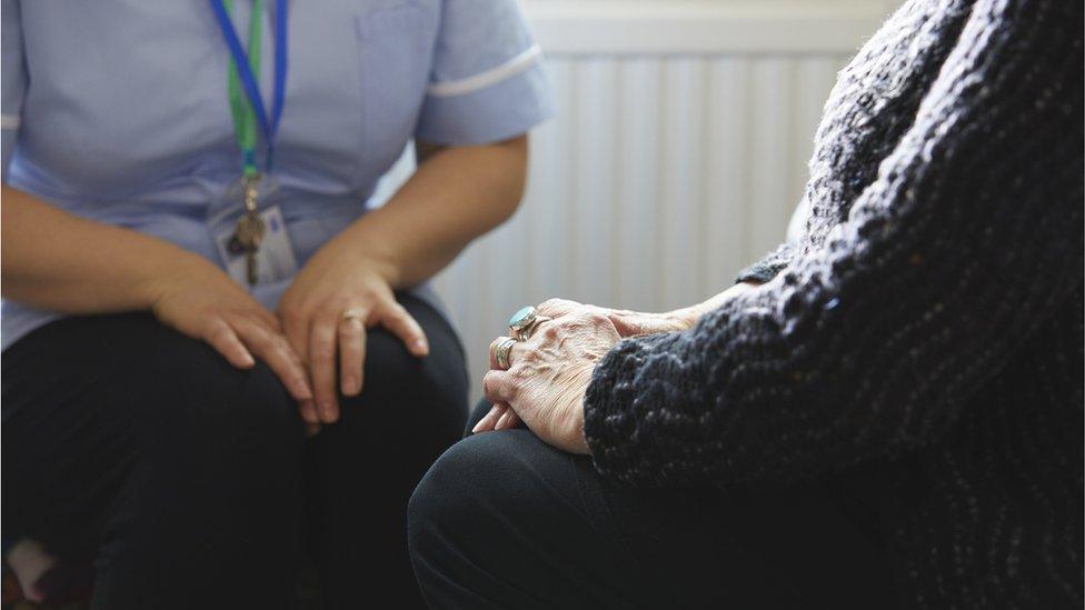 Nurse visiting patient at home