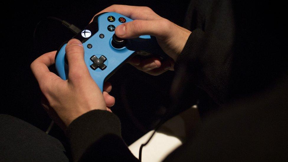 Close up of hands on an xbox controller