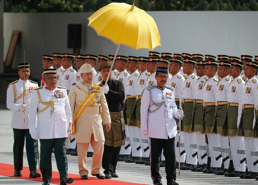 Sultan Muhammad V, third from left, inspects a ceremonial guard of honour during his welcome ceremony in Kuala Lumpur, Malaysia, Tuesday, 13 December 2016.