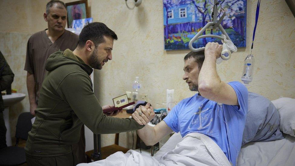 President Volodymyr Zelensky visits an injured Ukrainian serviceman