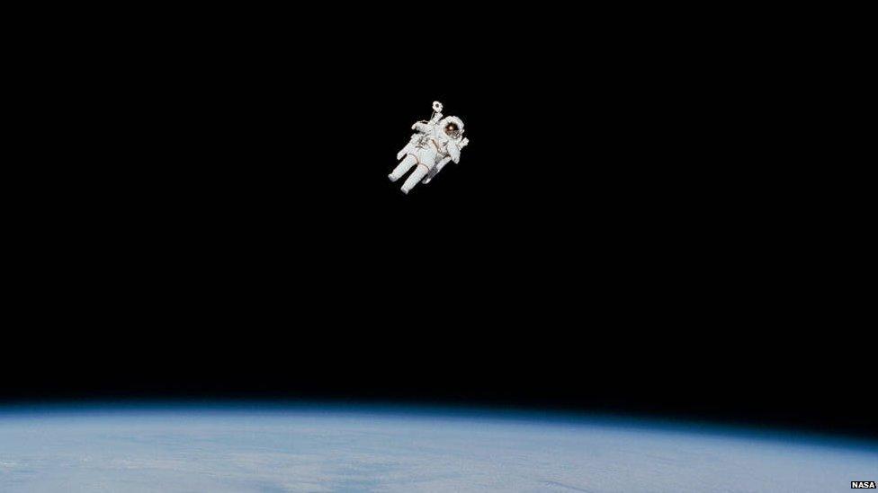 Astronaut floats in space