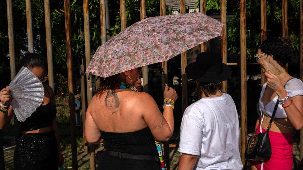 Fans of US singer Taylor Swift queue outside the Nilton Santos Olympic Stadium before Swift's concert, "Taylor Swift: The Eras Tour", amid a heat wave in Rio de Janeiro on November 18, 2023.