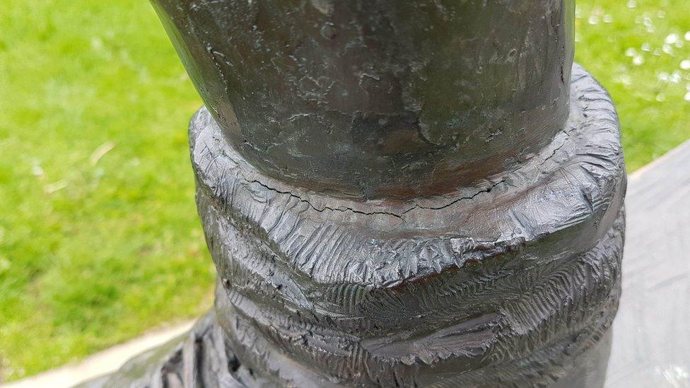 Damage to statue leg
