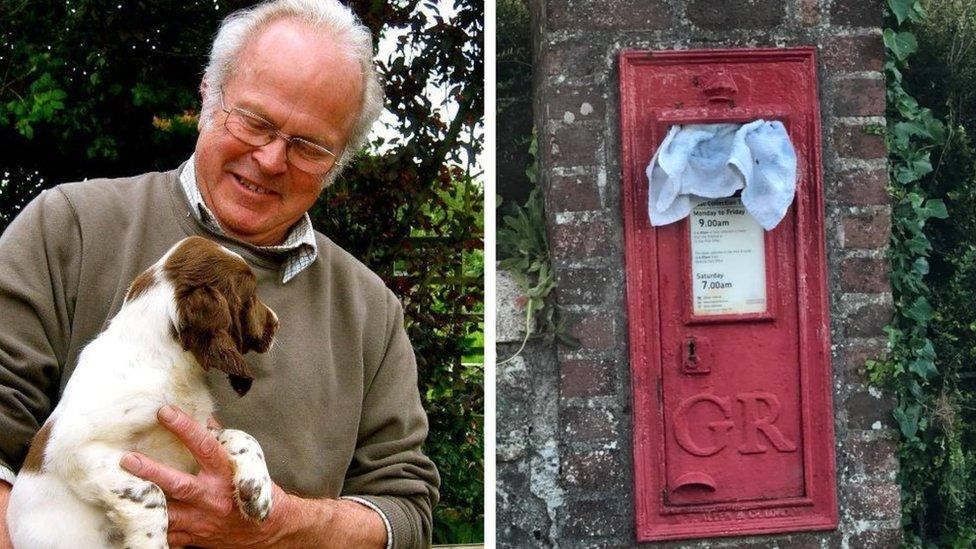 Rodney Harris with his dog/postbox with towel in letter box