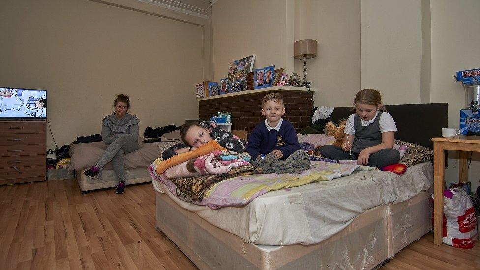 Carly Stutter and the children on their beds