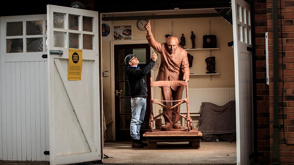 Andrian Melka working on the statue