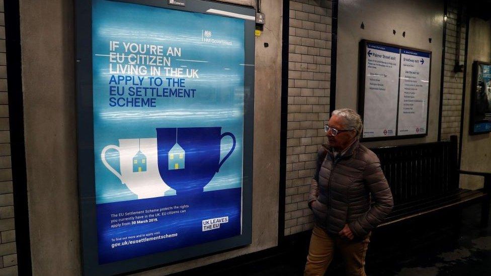 Sign in a Tube station encouraging EU nationals to apply for the settlement scheme