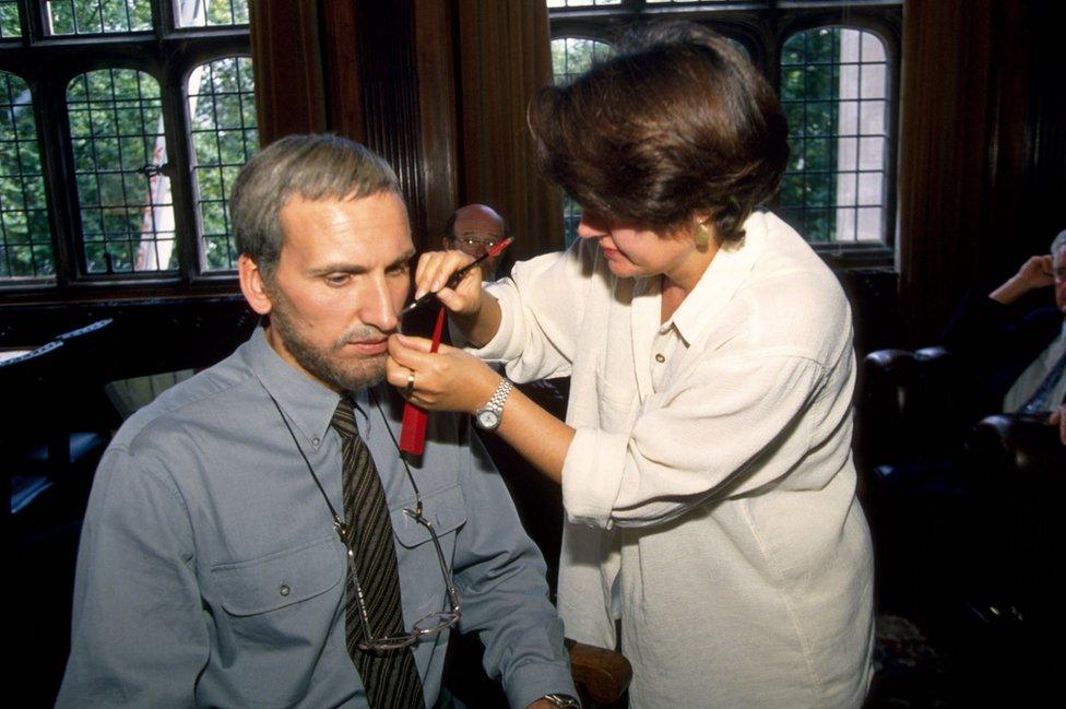 A make-up artist applies a grey wig and beard to Christopher Eccleston for one of the show's later episodes