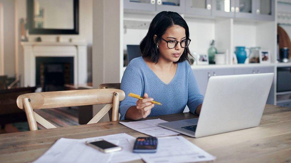 Woman at table with laptop