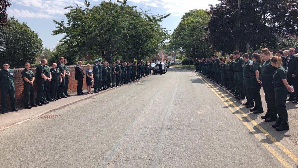 Colleagues and friends from the ambulance service gathering outside the church