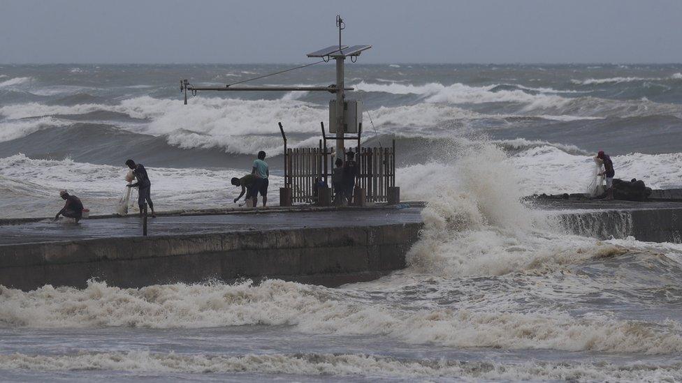 Filipino fishermen fish near the shoreline in the town of Aparri, Cagayan province, Philippines, 14 September 2018