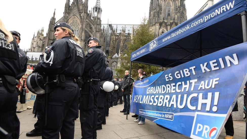 Police secure the area as sympathizers of German right-wing party Pro NRW protest. The banner reads: "There is no such thing as a right to abuse asylum"