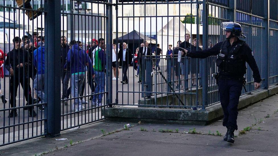 Police use pepper spray against fans outside the ground as the kick off is delayed during the UEFA Champions League Final