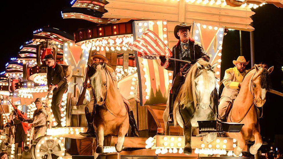 American cowboy-themed illuminated carnival cart