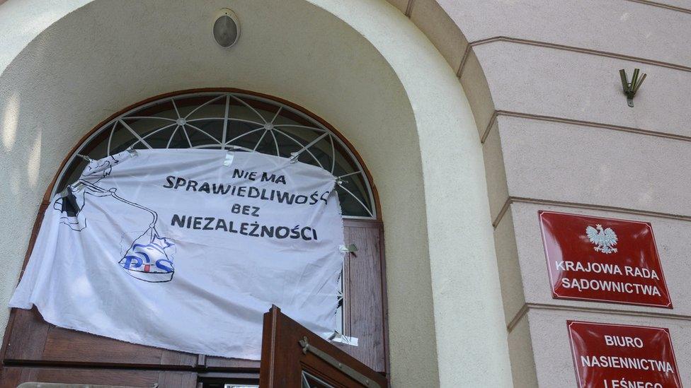 Protest banner outside the national court in Warsaw