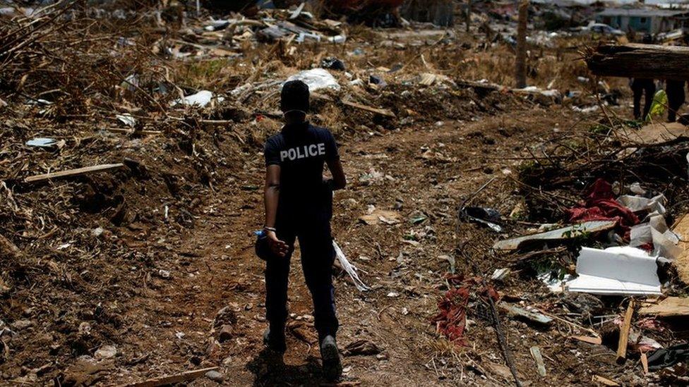 A police officer searches for the dead in the Abaco Islands