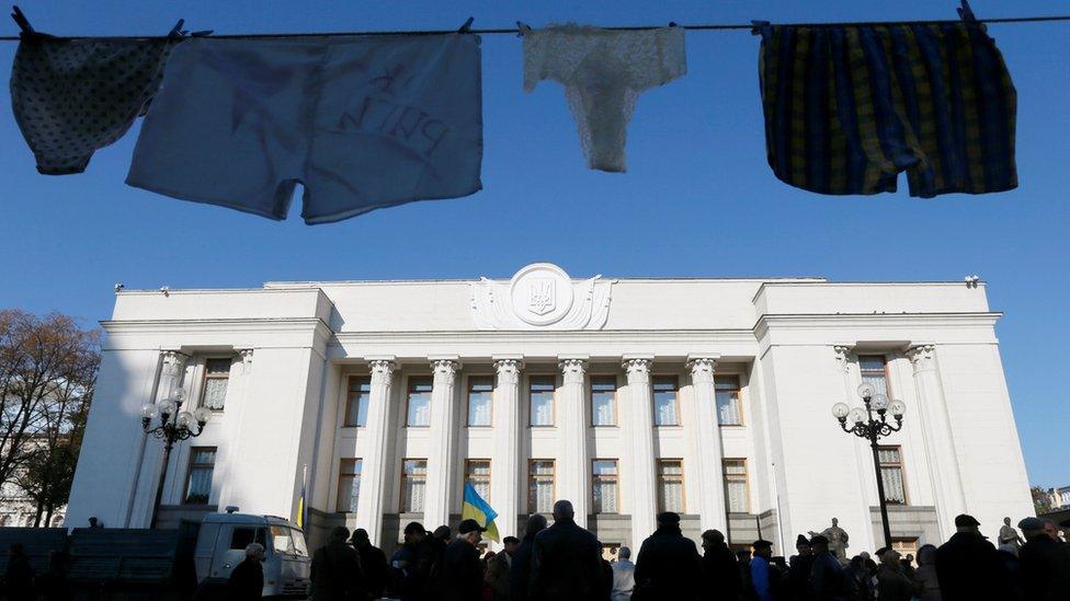 Underwear hung by anti-corruption activists is on display during a rally to demand officials register their income declarations in the e-declaration system in front of the Ukrainian parliament building in Kiev, Ukraine, October 18, 2016