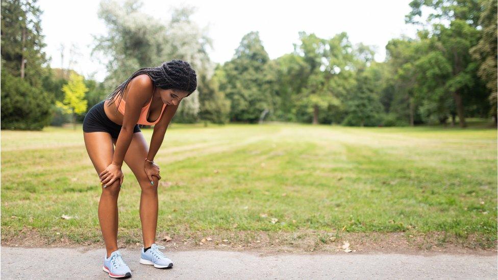 Woman taking a breather after running in a park