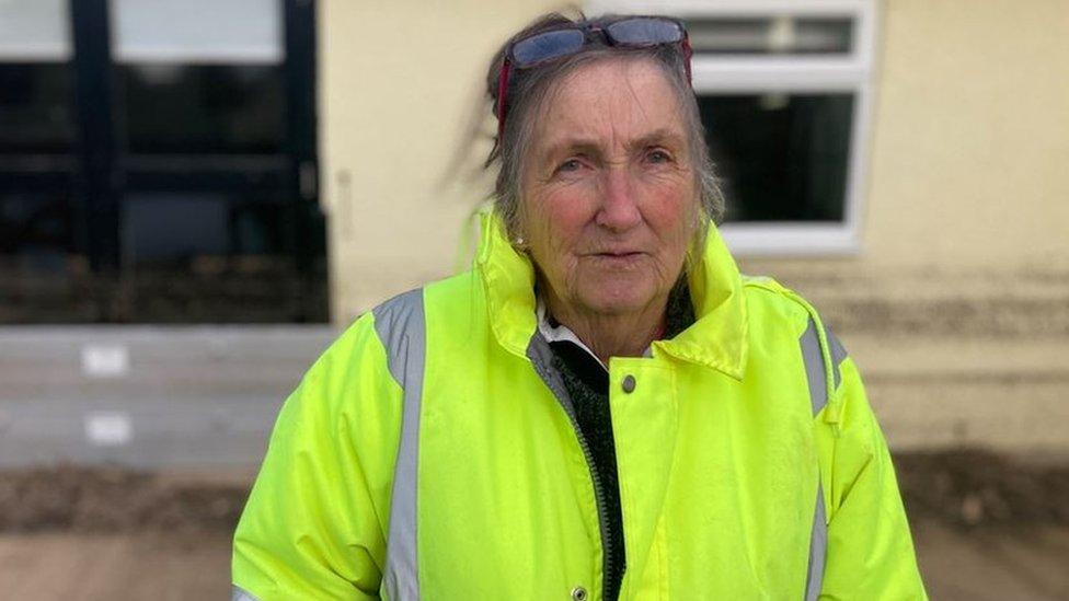 Ellie Richardson standing outside the pub wearing a hi-vis vest