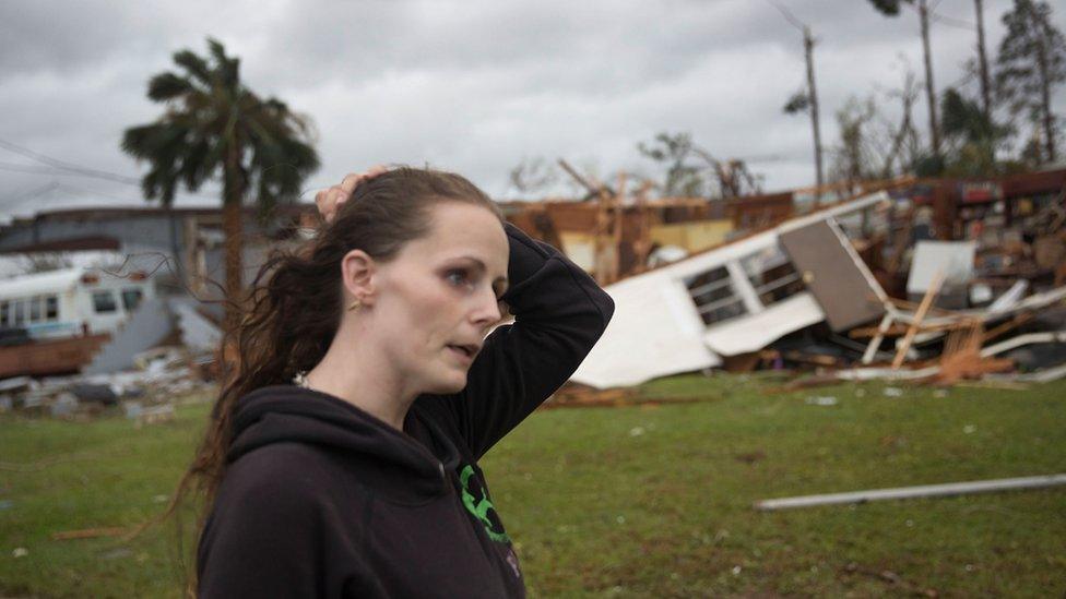 Haley Nelson stands in front of what is left of one of her father's trailer homes after hurricane Michael passed through the area, 10 October 2018