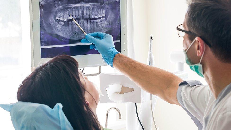 Dentist showing a patient an x-ray