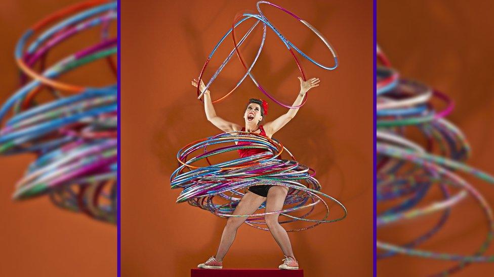 Dunja Kuhn, completing the most hula-hoops spun simultaneously on multi-body parts.