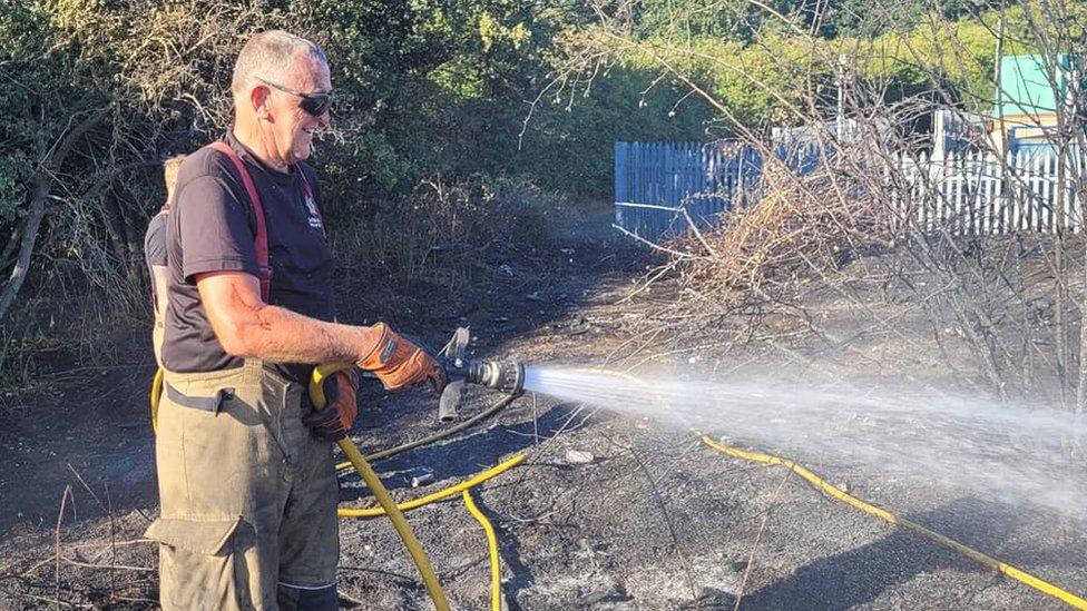 A firefighter putting out a fire in Sudbury, Suffolk