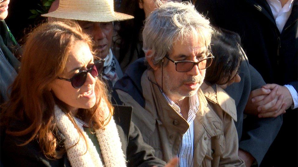 Two people mourning at the funeral