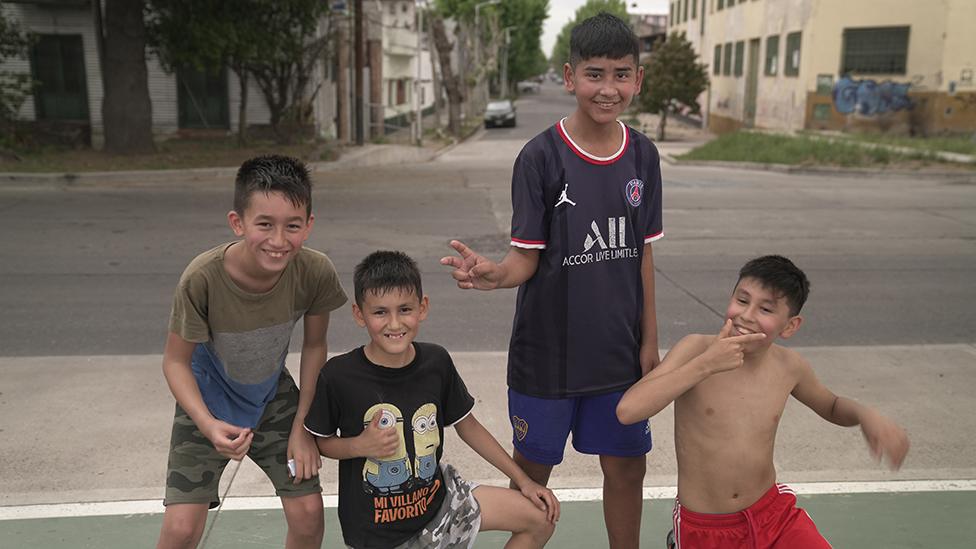 Group of young boys playing football in the port area of Buenos Aires