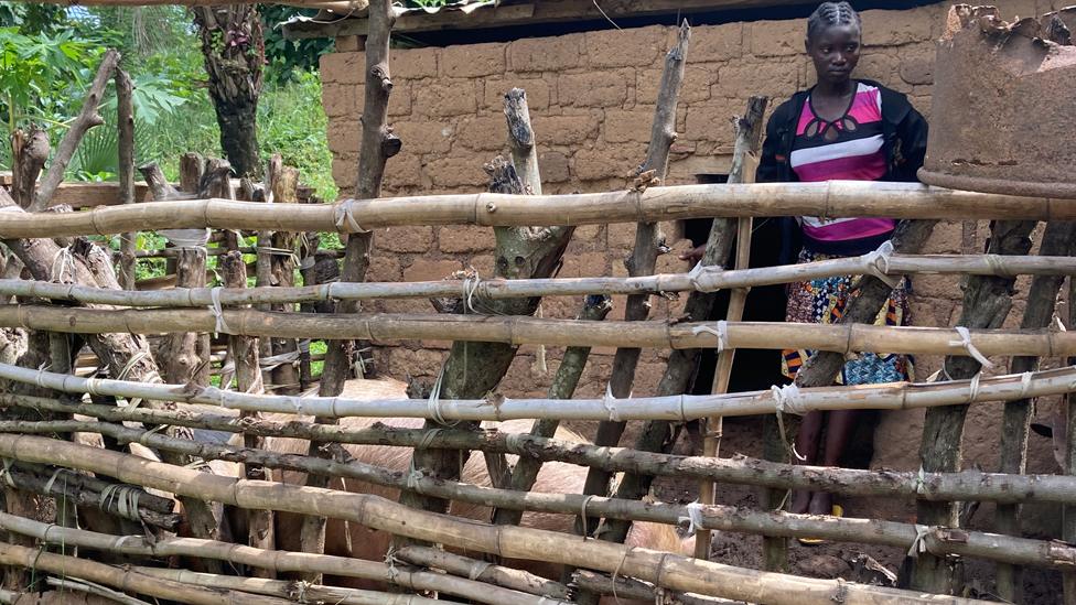 Jovanie Renemeya by a pig pen in Bambari, CAR