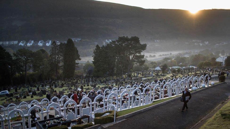 The sun rises at Aberfan as people observe a minute's silence for the disaster