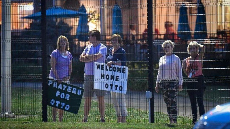 Local residents hold signs of support to welcome home Otto Warmbier at Lunken Airport in Cincinnati, Ohio, US, June 13, 2017.