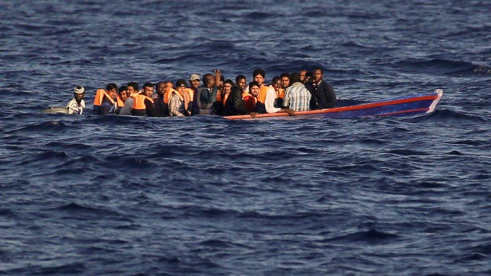 Migrants and refugees fleeing Libya aboard a wooden boat in the Mediterranean sea on 28 August 2016