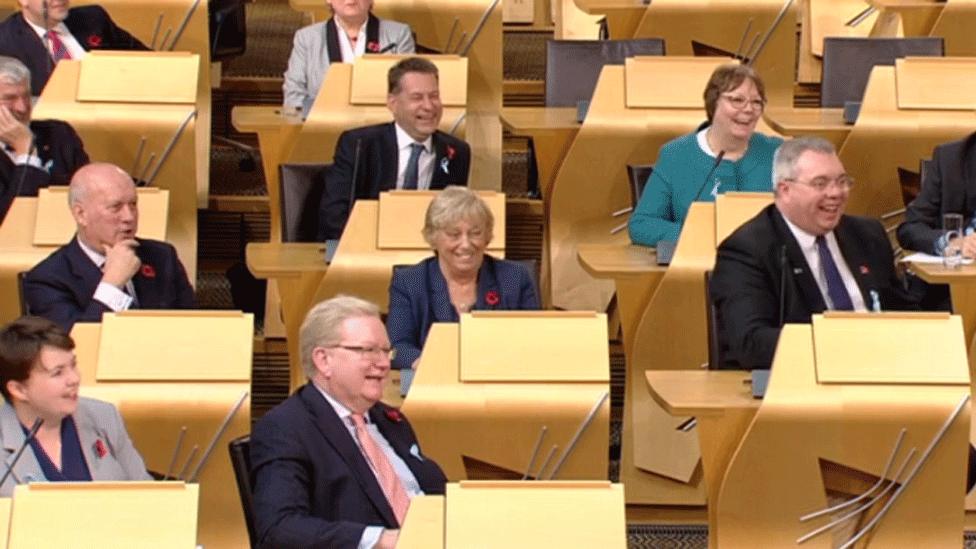 Holyrood chamber showing MSPs laughing