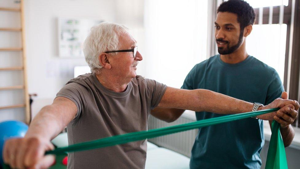 physiotherapist working with a man