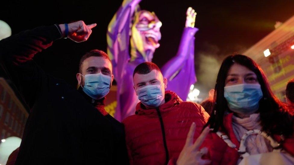 Revellers wear masks to protect themselves from the virus as they attend the Nice carnival on 25 February 2020