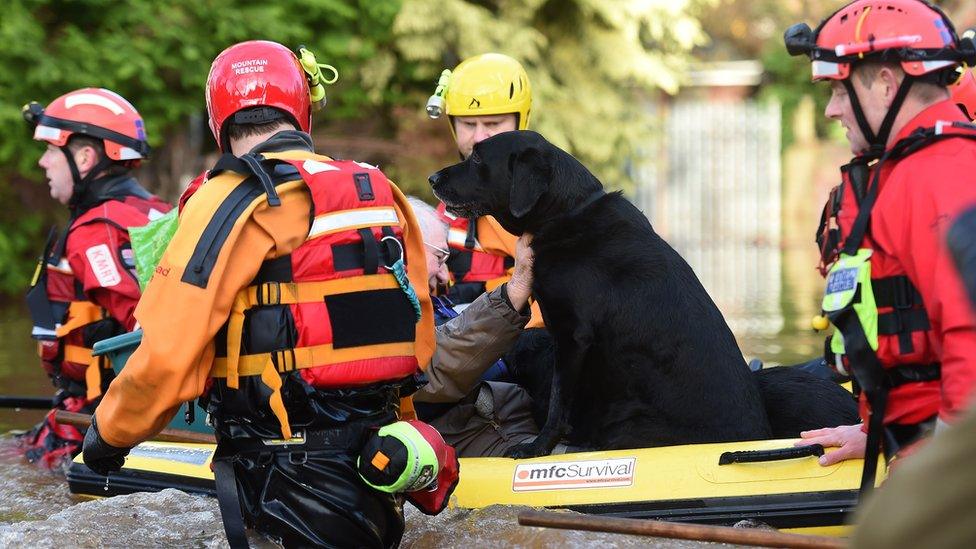 The emergency services have helped rescue people and their pets using rubber dinghies to keep them dry.