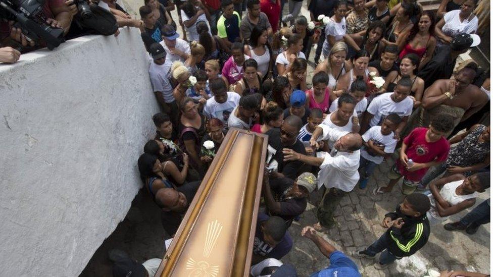 Relatives and friends carry the coffin containing the remains of Eduardo Felipe Santos Victor, a teenager who was shot dead at Morro da Providencia favela, in Rio de Janeiro, Brazil on 30 September 2015