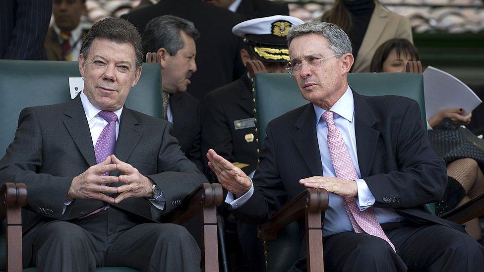 Juan Manuel Santos and Alvaro Uribe at a military event.