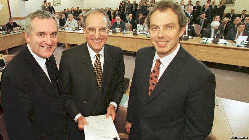 British Prime Minister Tony Blair (R), US Senator George Mitchell (C) and Irish Prime Minister Bertie Ahern (L) smiling on April 10, 1998, after they signed an historic agreement