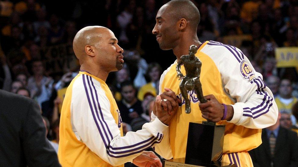 Kobe Bryant holding his MVP award in 2008.