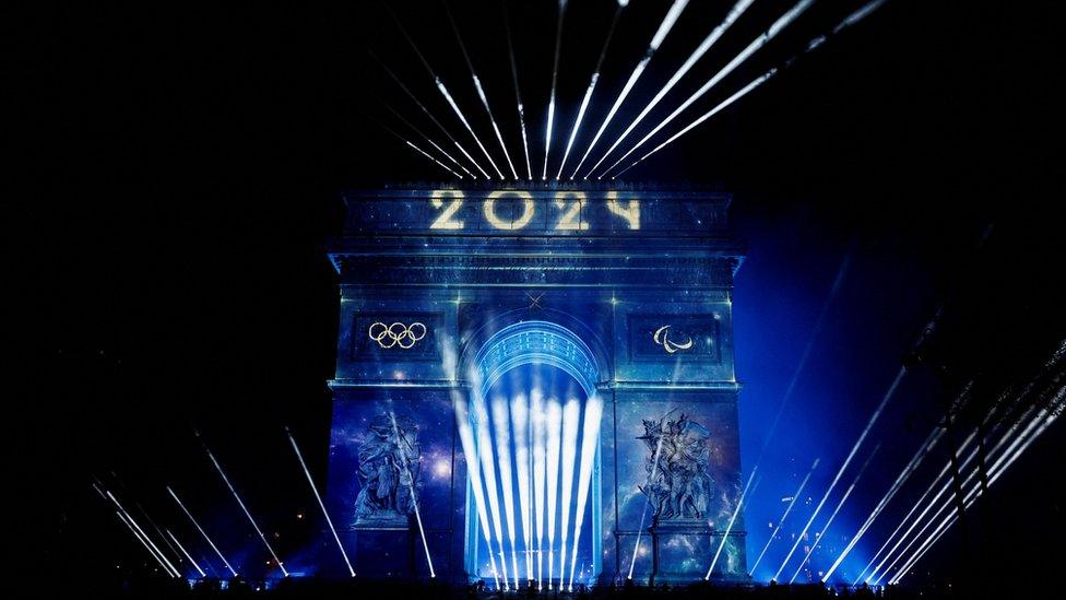 A light show lights up the Arc de Triomphe in Paris