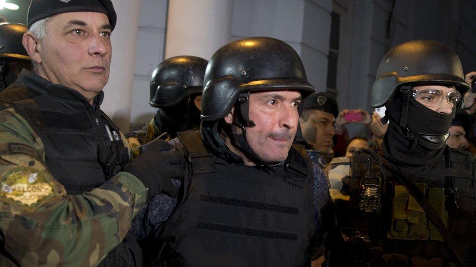 Jose Lopez, centre, escorted by police outside station in outskirts of Buenos Aires, Argentina, Tuesday, June 14, 2016