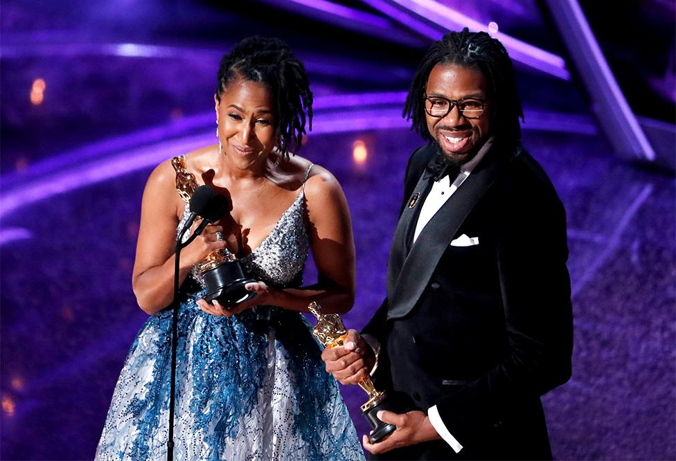 Karen Rupert Toliver and Matthew A. Cherry hold Oscars