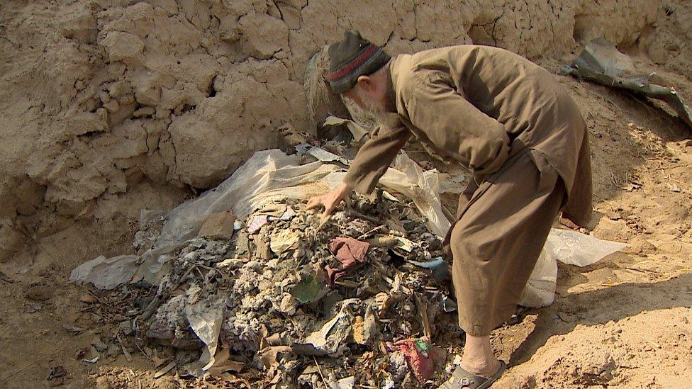 Nasirullah with his damaged shop