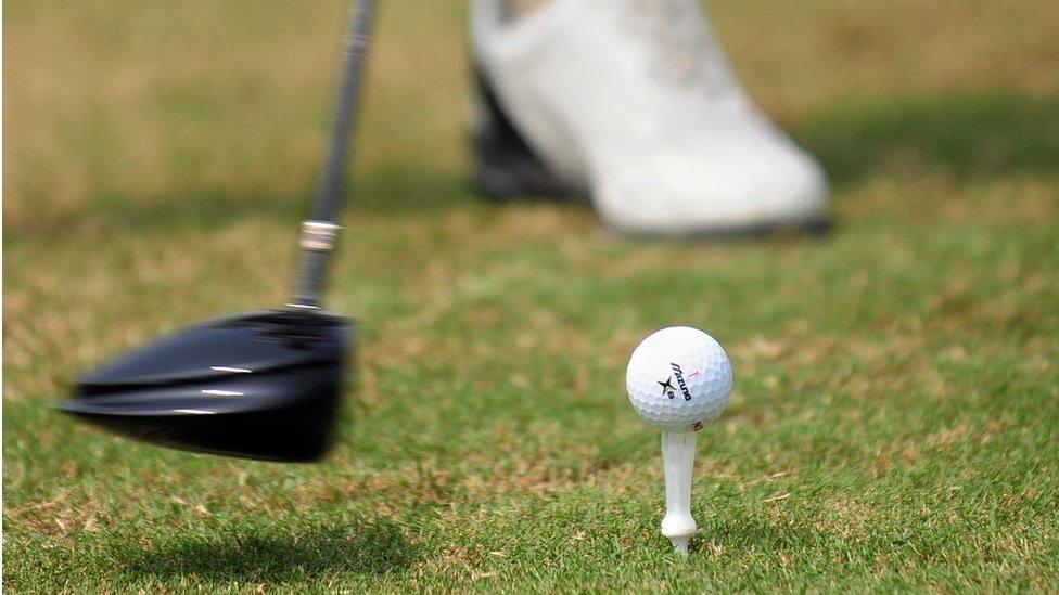 A golfer tees off at a course in Sanya on 25 October 2009 in China's southernmost tropical island province of Hainan