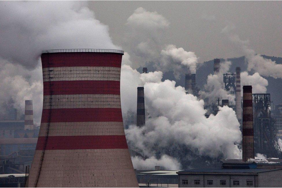 Smoke billows from smokestacks and a coal fired generator at a steel factory on 19 November 2015 in the industrial province of Hebei, China.